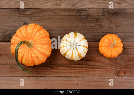 High angle shot of three different decorative pumpkins. Horizontal format. Stock Photo