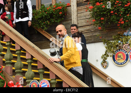 Munich, Germany. 05th Oct, 2014. FC Bayern Muenchen coach Pep Guardiola and his wife Cristina enter the 'Kaeferzelt' during the 181st Oktoberfest in Munich, Germany, 05 October 2014. The annual beer festival ends on 05 October 2014. PHOTO: FELIX HOERHAGER/dpa/Alamy Live News Stock Photo