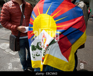A Tibetan is showing his nation's colours at a protest rally during the visit of China's Premier Li Keqiang in Bern, Switzerland Stock Photo