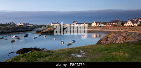 Porth Diana with houses of Trearddur Bay in late evening light on the western coast of Holy Island part of the Isle of Anglesey Stock Photo