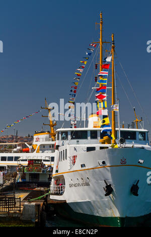 ISTANBUL – AUGUST 30: A ferry at Eminonu passenger port on August 30, 2012 in Istanbul, Turkey. Ferries decorate by flags for Vi Stock Photo