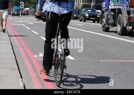 A cyclist approaching a cycle lane in a bus lane in London, England Stock Photo