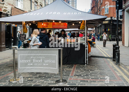 LONDON, UK - SEPTEMBER 26, 2014: People are buying freshly prepared finger food on the London Street Food Union market in Soho o Stock Photo