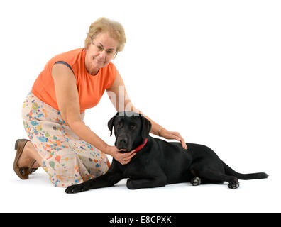 Woman petting black labrador retriever dog cut out isolated on white background Stock Photo
