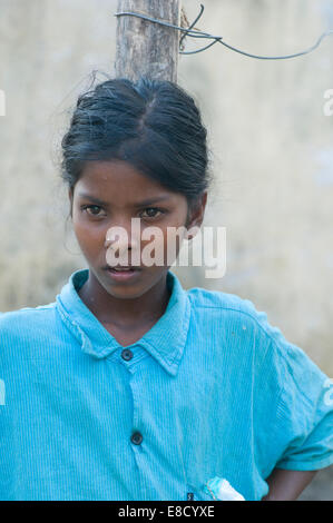 Young pure smiling Indian village girl in blue shirt Stock Photo