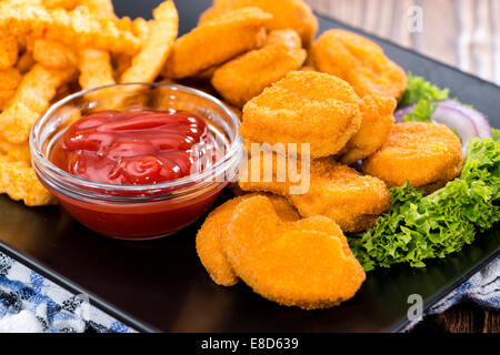 Chicken Nuggets with French Fries (detailed close-up shot) Stock Photo