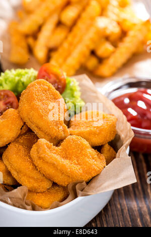 Chicken Nuggets with French Fries (detailed close-up shot) Stock Photo