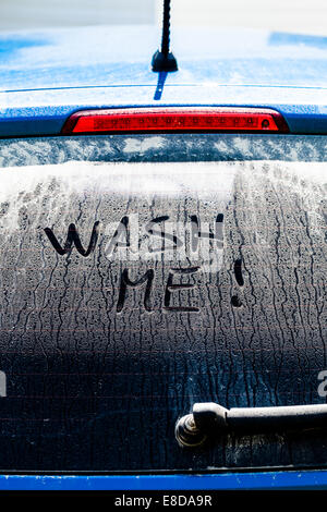 Wash Me Words on a Dirty Rear Car Window Stock Photo