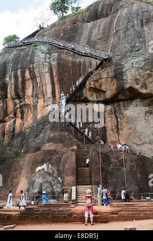 Visitors climbing the steep stairs to the rock fortress of Sigiriya, UNESCO World Heritage Site, Sigiriya, Sri Lanka Stock Photo