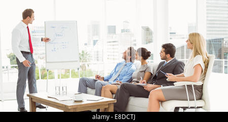 Businessman giving presentation in office Stock Photo