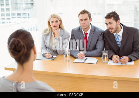 Business people interviewing woman Stock Photo