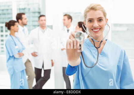 Portrait of a female surgeon using stethoscope Stock Photo