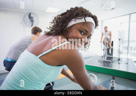 Spin class working out with motivational instructor Stock Photo
