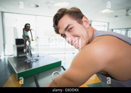 Handsome man smiling at camera in spin class Stock Photo