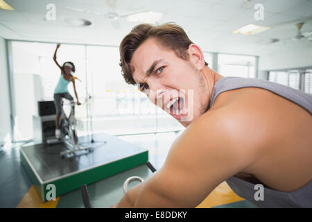 Handsome man smiling at camera in spin class Stock Photo