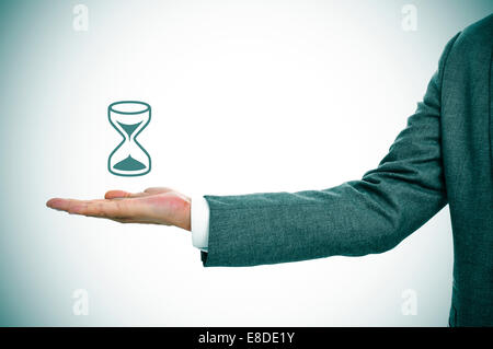 a businessman holding an illustration of an hourglass in his hand Stock Photo