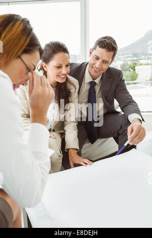 Couple talking to female architect Stock Photo