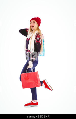 Festive blonde holding shopping bags Stock Photo