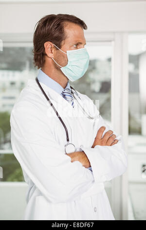 Male doctor wearing surgical mask, close up Stock Photo - Alamy