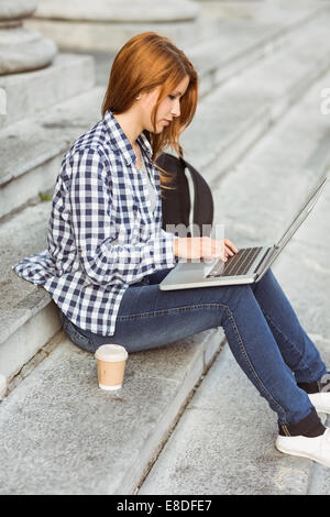 Young student using her laptop to study outside Stock Photo
