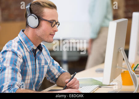 Concentrated photo editor using digitizer in office Stock Photo