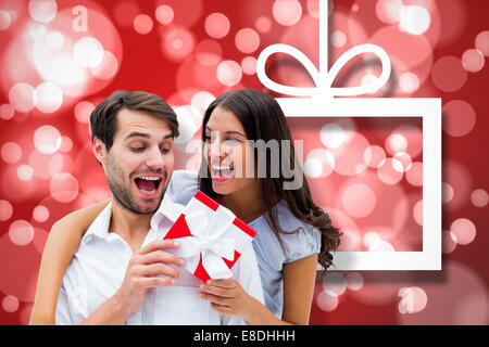 Composite image of woman surprising boyfriend with gift Stock Photo
