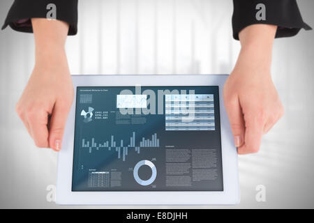 Composite image of businesswomans hands holding tablet Stock Photo