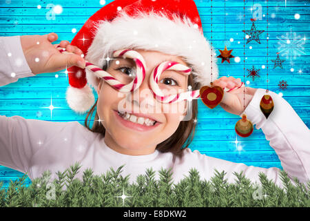 Composite image of festive little girl smiling at camera Stock Photo