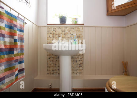 A downstairs cloakroom toilet and handbasin in a home in the UK. Stock Photo