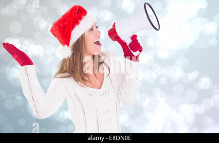 Composite image of festive blonde shouting through megaphone