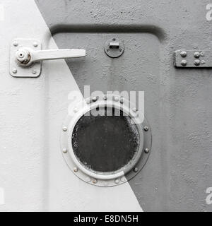 Background of an old ship metal door with a round window Stock Photo