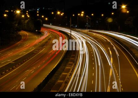 Red and white traffic car light beam trails on Braddell Road flyover Singapore night photo Stock Photo