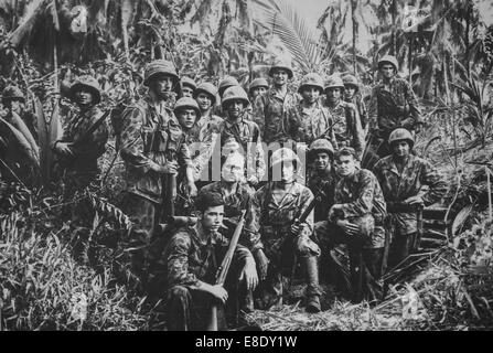 World War II Two United States Marine Corps Raiders January 1944 in front of a Japanese dugout on Cape Totkina,  Solomon Islands Stock Photo