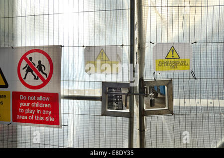 Hidden from view behind metal railings and translucent plastic screen locked gates bar access to dangerous plant machinery H&S Stock Photo