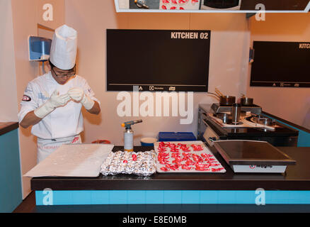 Earls Court, London UK. 6th October 2014. The Restaurant Show opening day. Competition Kitchen holds the 1st UK Sugar Championship Junior Trophy 2014. Rudy Kwun Wing, YIU of the Hotel Café Royal in London creating his sugar sculpture. Credit:  Malcolm Park editorial/Alamy Live News. Stock Photo