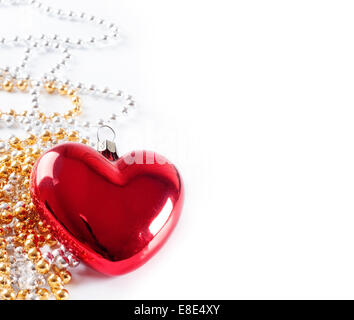 Christmas background with red heart and golden beads Stock Photo
