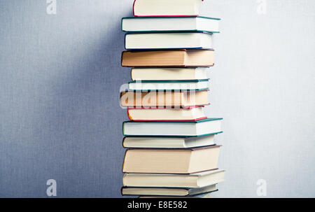Very high stack of books in the middle Stock Photo