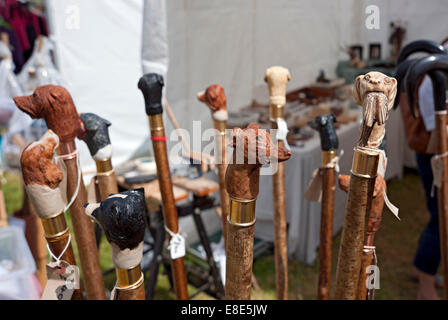 Close up of display hand carved wooden walking stick sticks for sale on stall England UK United Kingdom GB Great Britain Stock Photo