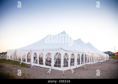 Party or event white tent during the evening Stock Photo
