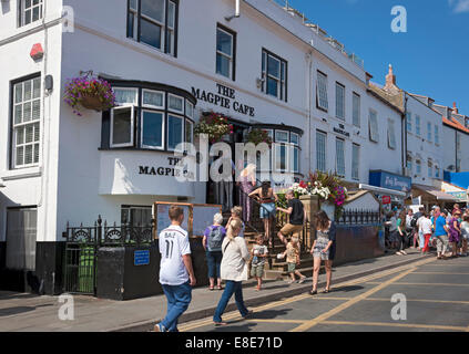 People outside the famous Magpie Cafe fish and chip chips shop restaurant in summer Whitby North Yorkshire England UK United Kingdom Great Britain Stock Photo