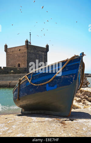 Vertical view of the fortress in Essaouira with a moored fishing boat on a sunny day. Stock Photo