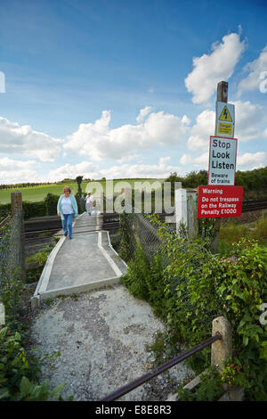 Walkers using a railway foot crossing near Eynsford, Kent, UK. Stock Photo