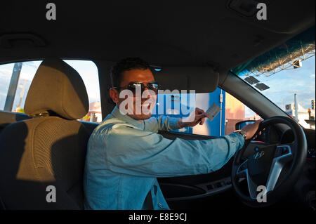 Horizontal portrait of a young Moroccan man driving a left hand drive car on the new a7 autoroute. Stock Photo