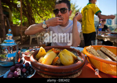 Horizontal portrait of a Moroccan man eating traditional tajine at a restaurant. Stock Photo