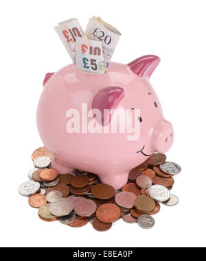Pink piggy bank with UK sterling coins and notes Stock Photo