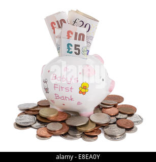Baby piggy bank with UK sterling coins and notes Stock Photo