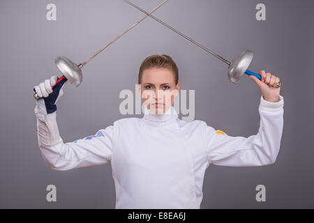 Young woman engaging in fencing Stock Photo