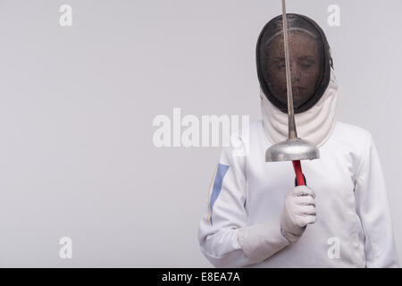 Young woman engaging in fencing Stock Photo