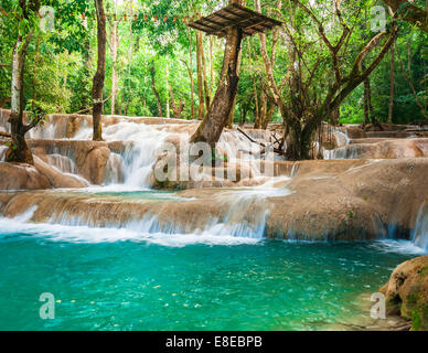 Jangle landscape with amazing turquoise water of Kuang Si cascade waterfall at deep tropical rain forest. Luang Prabang, Laos tr Stock Photo