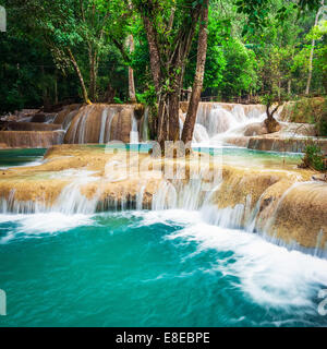 Jangle landscape with amazing turquoise water of Kuang Si cascade waterfall at deep tropical rain forest. Luang Prabang, Laos tr Stock Photo